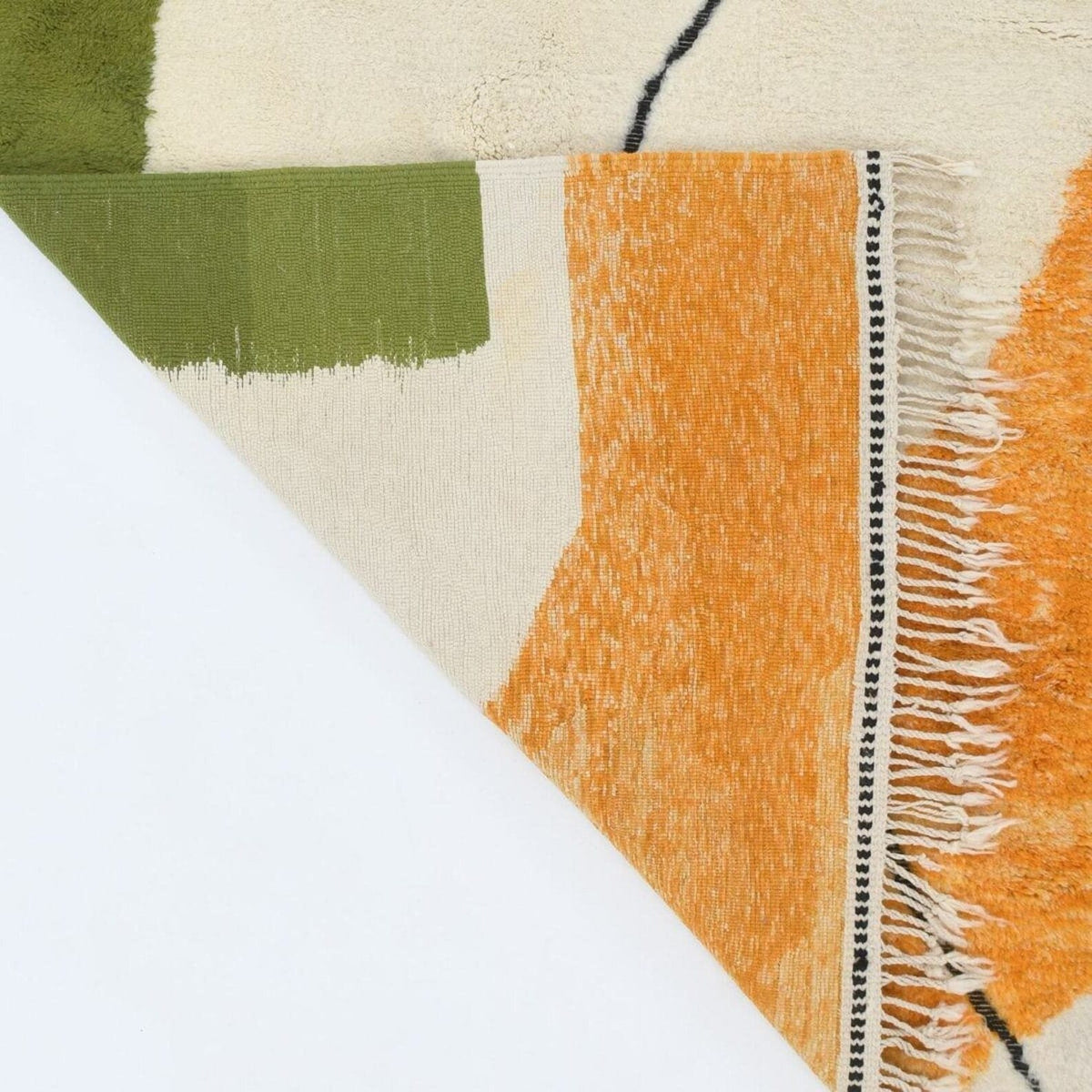 Detail close-up of the orange and green geometric patterns on textured fabric.