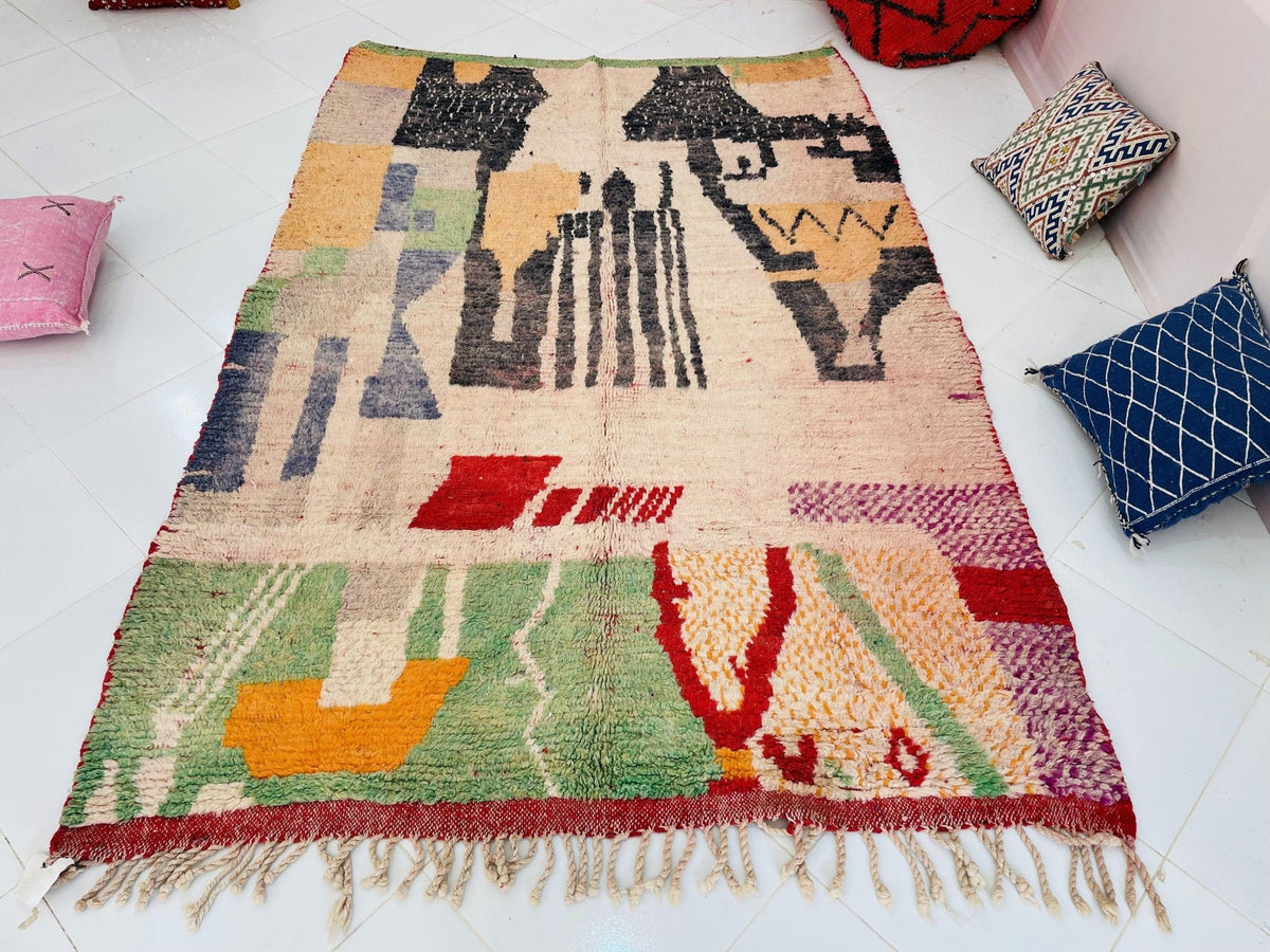 Detail close-up of the rug's zigzag pattern with a textured weave in beige, black, and red.