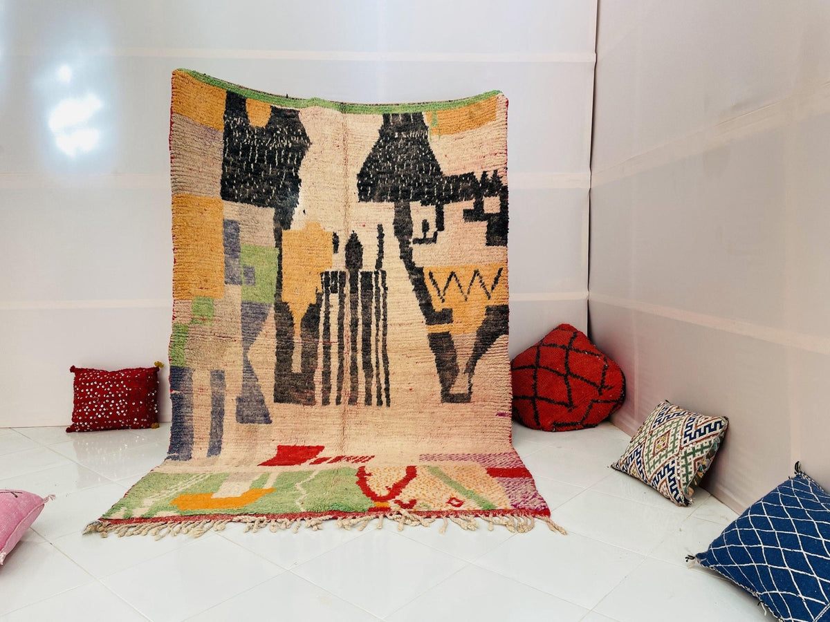 Lifestyle shot of a vintage Moroccan rug featuring tribal patterns in yellow, black, and red.