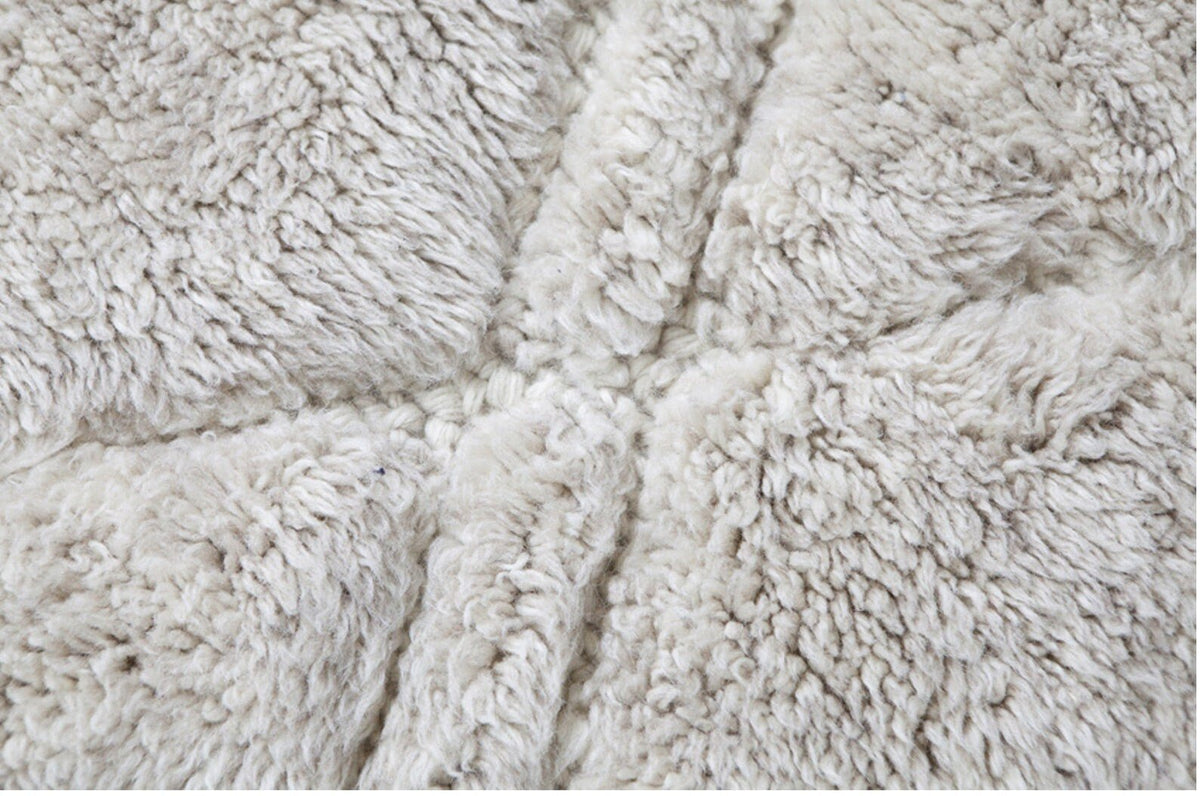 Close-up detail of the geometric design on a black and off-white Beni Ourain Moroccan rug.