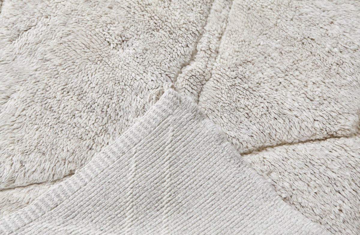 Close-up detail of the textured surface of a black and off-white Beni Ourain Moroccan rug.
