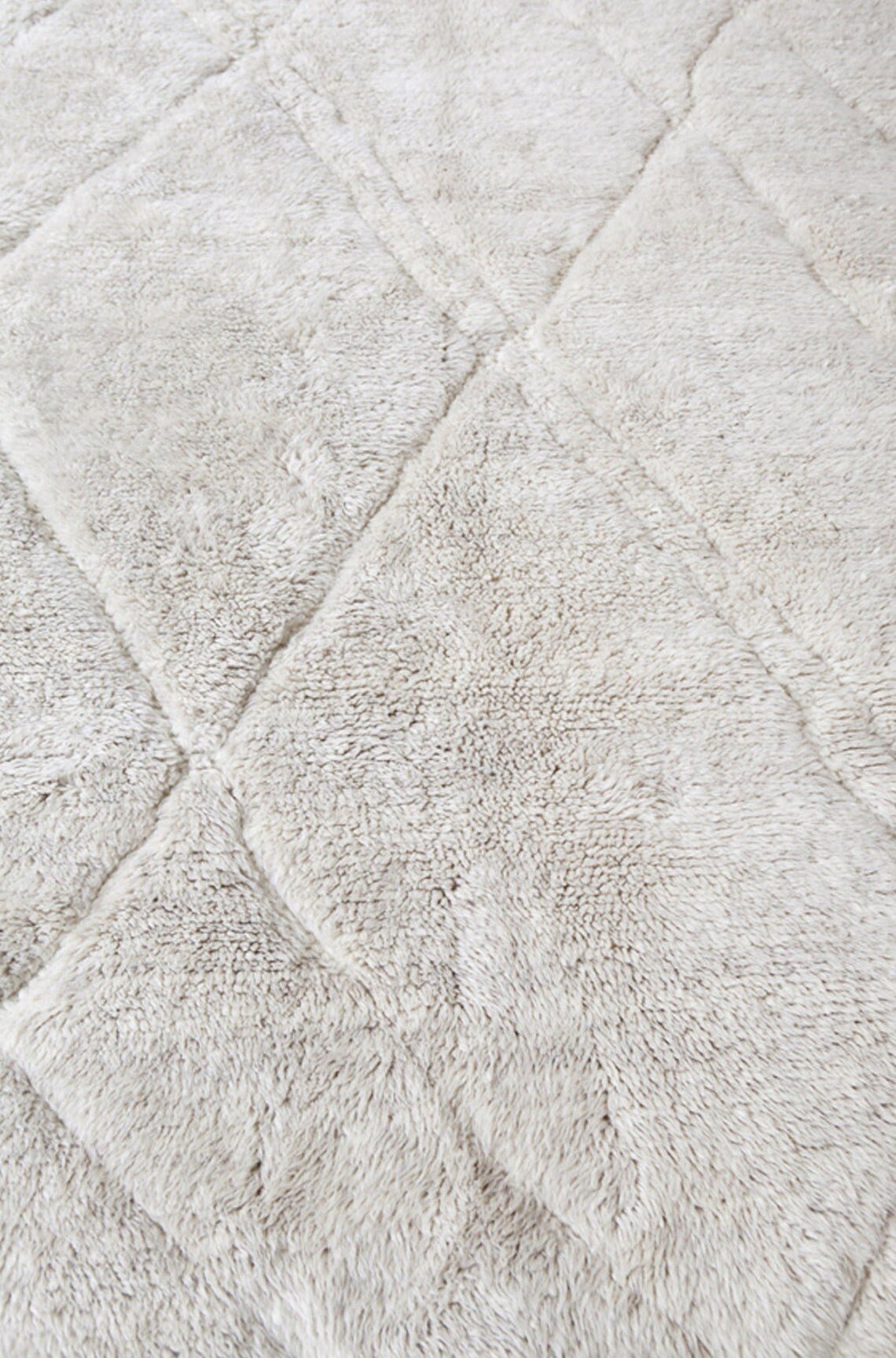 Front view of a textured abstract Beni Ourain Moroccan rug showcasing geometric designs in black and off-white.