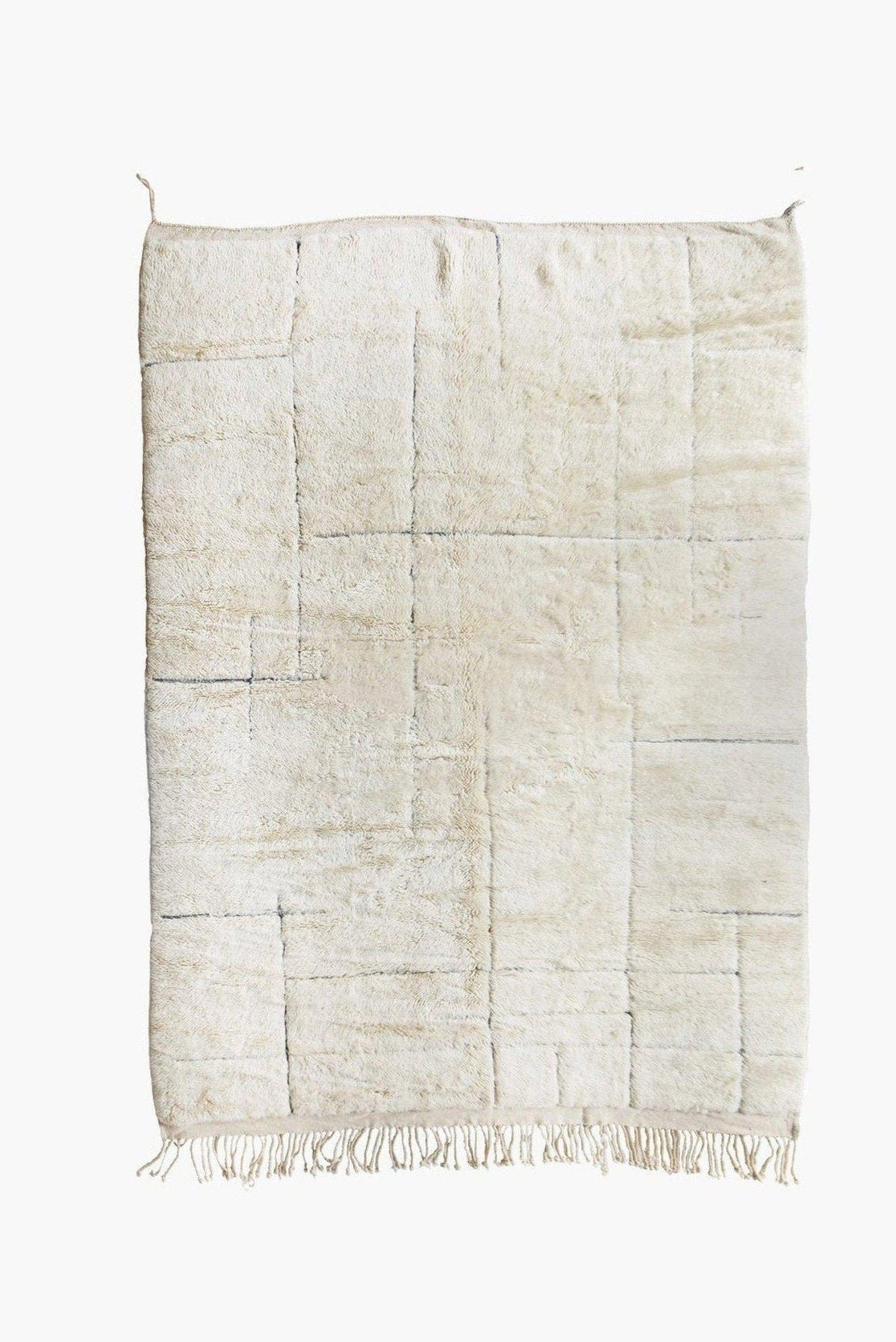 Detail close-up of an off-white textured Beni Ourain Moroccan rug on a white background.