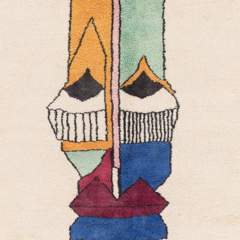 Detail of the artsy face rug with abstract design and colorful patterns.