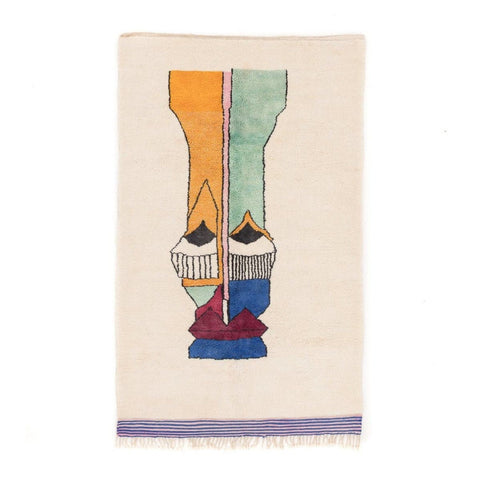 Front view of a colorful area rug with geometric design and fringe edges.
