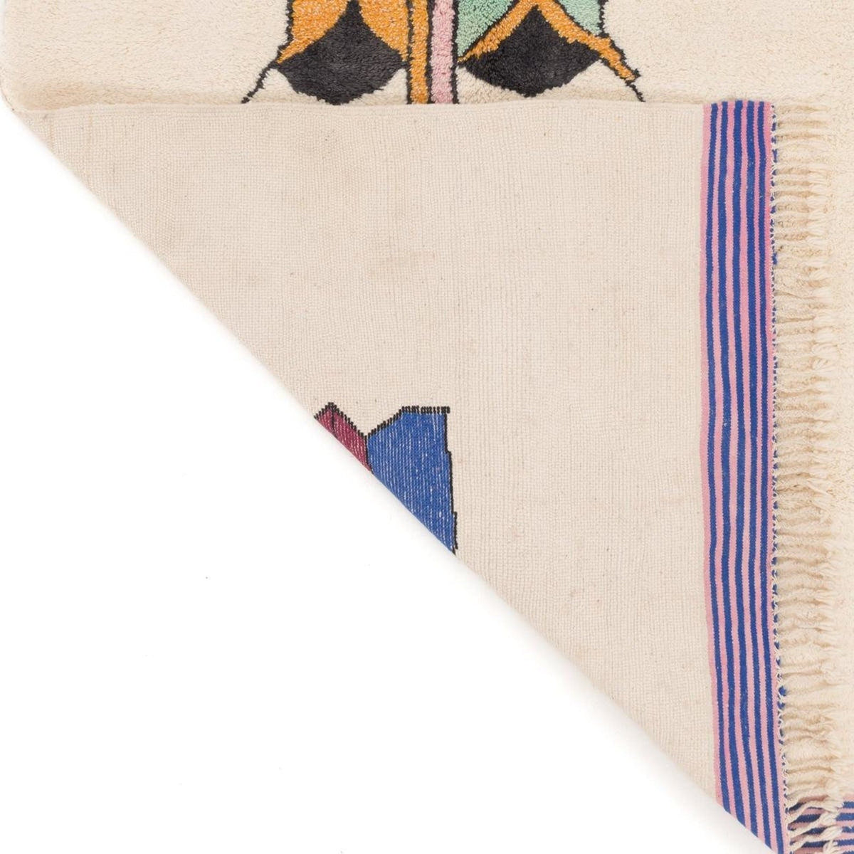 Detail shot of the rug edge highlighting fringe detail and colorful accents.