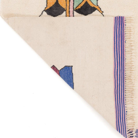 Detail shot of the rug edge highlighting fringe detail and colorful accents.