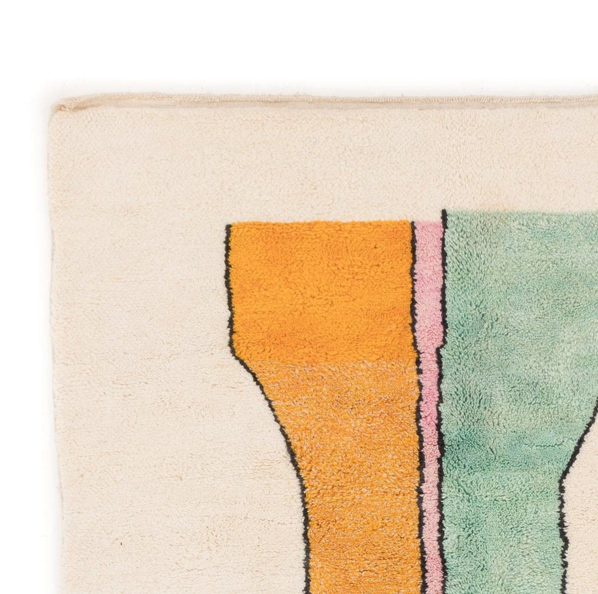 Close-up detail of the rug corner showcasing colorful patterns and soft texture.