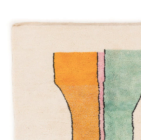 Close-up detail of the rug corner showcasing colorful patterns and soft texture.