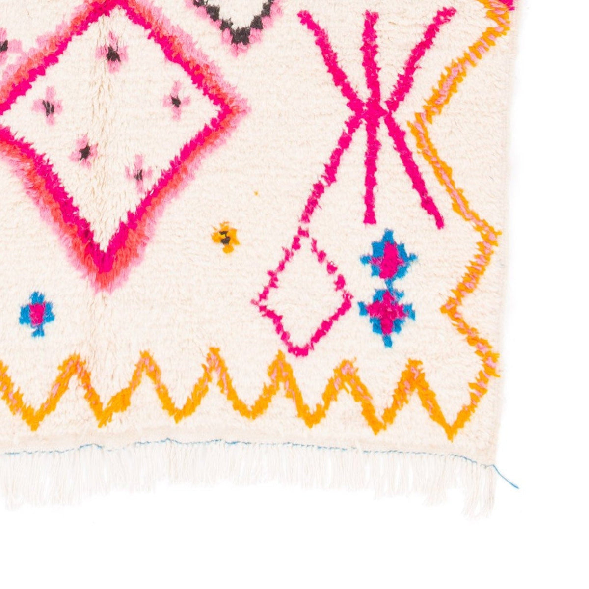 Front view of a colorful pink and yellow tribal rug showcasing geometric designs.