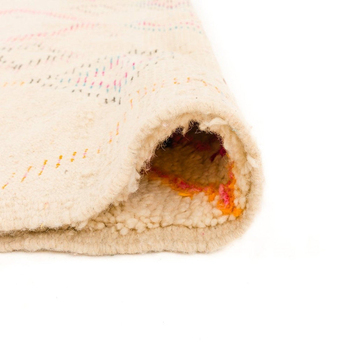 Detail shot of a colorful patterned rug in pink and orange showcasing geometric patterns.