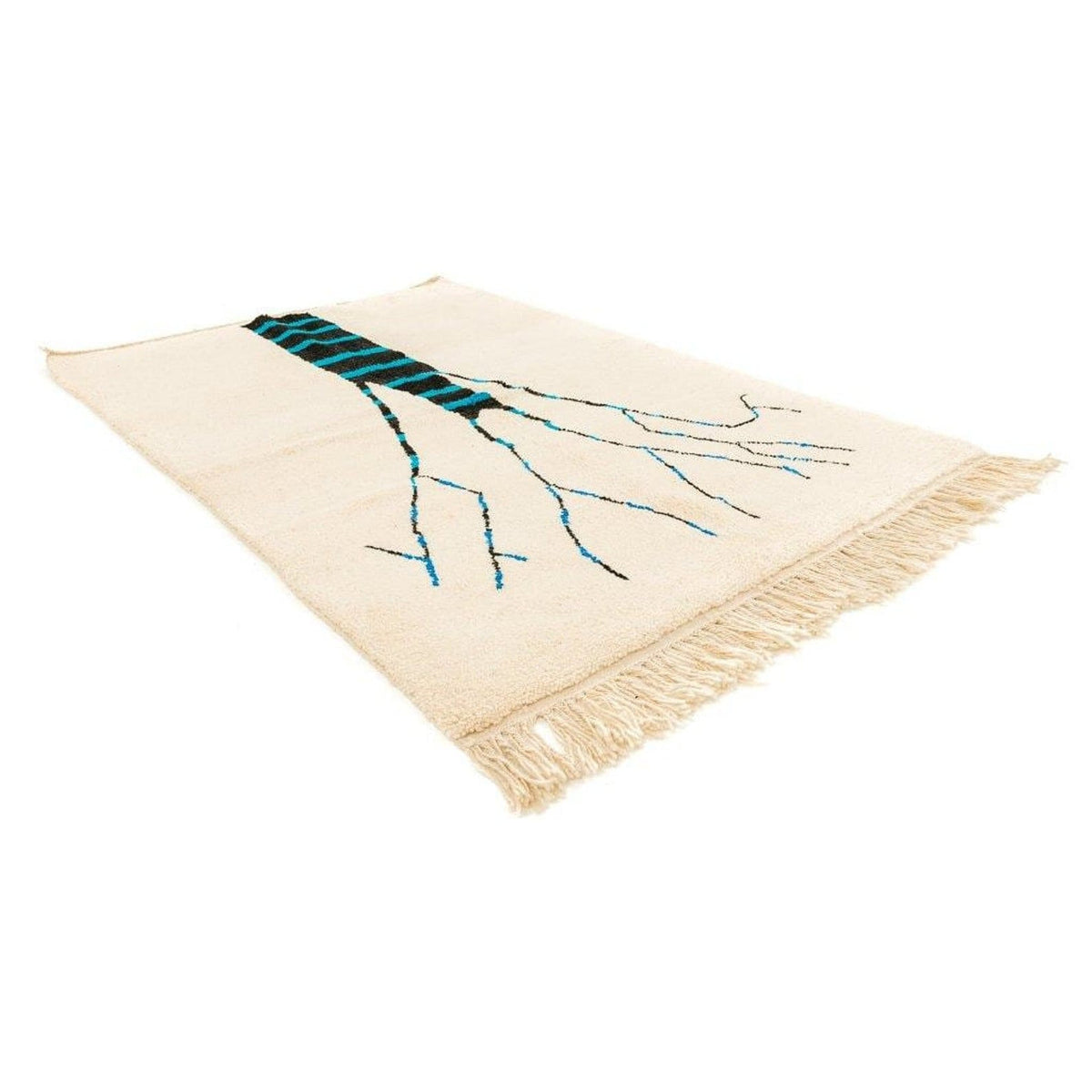 Detail view of the cream tree design rug with fringe edges, showcasing the tree design in cream, blue, and black.
