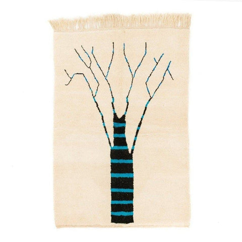 Front view of the cream tree design rug featuring abstract patterns in beige, black, and blue.