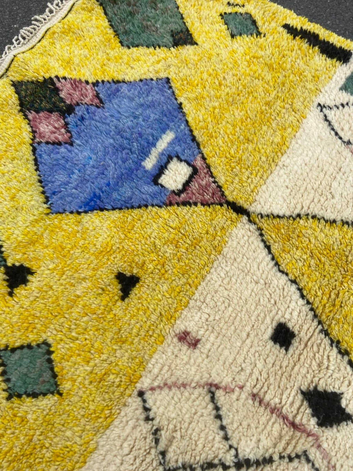 Front view of a blue and yellow tribal Azilal rug showcasing geometric designs.