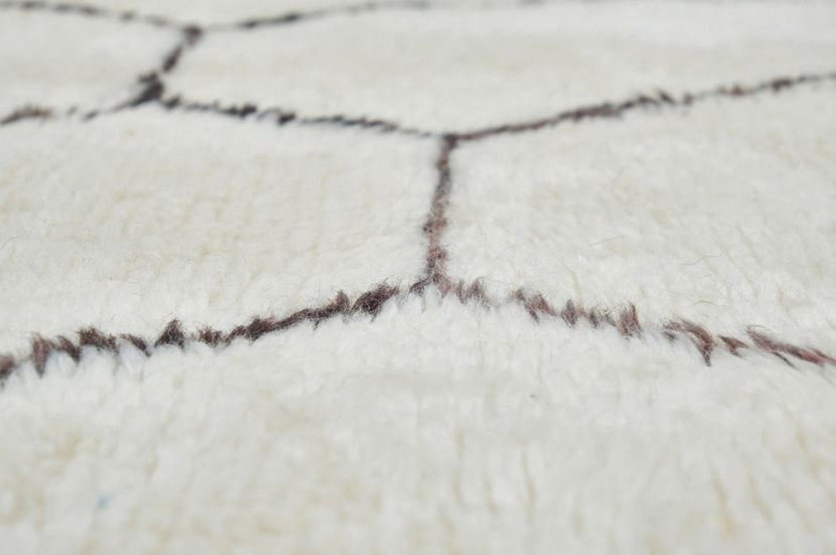 Front view of the black and off-white Beni Ourain Moroccan rug showcasing its abstract design.