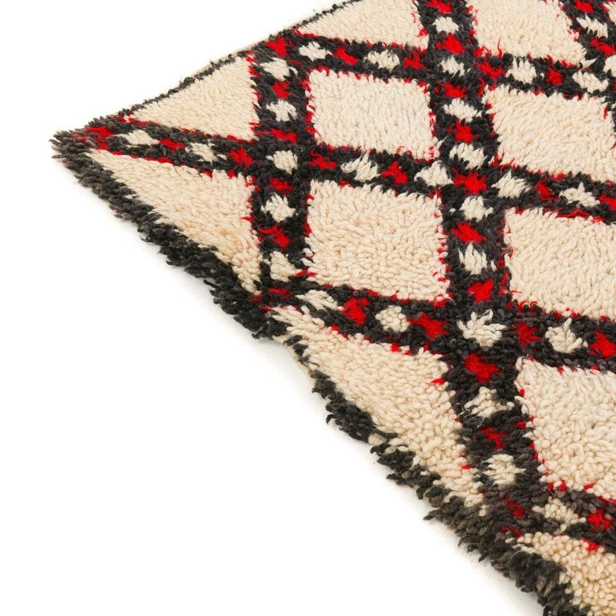 Close-up of the vintage-style Beni Ourain rug with a diamond pattern and fringe edges.