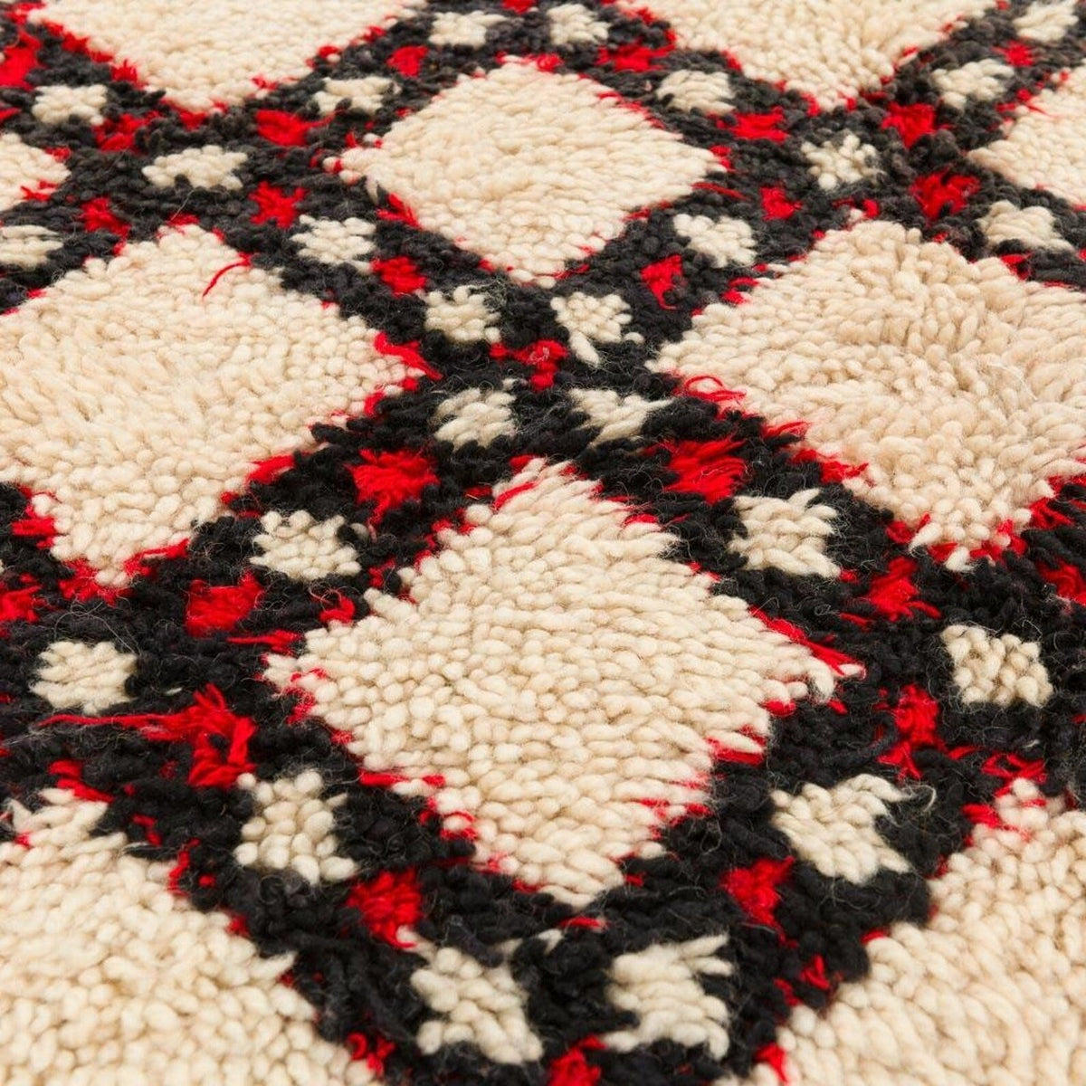 Close-up detail of the brown checkered Beni Ourain rug highlighting its geometric pattern.