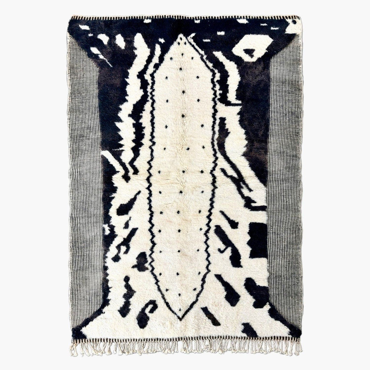 Front view of the black and white zebra print rug with fringe edges on a white background.