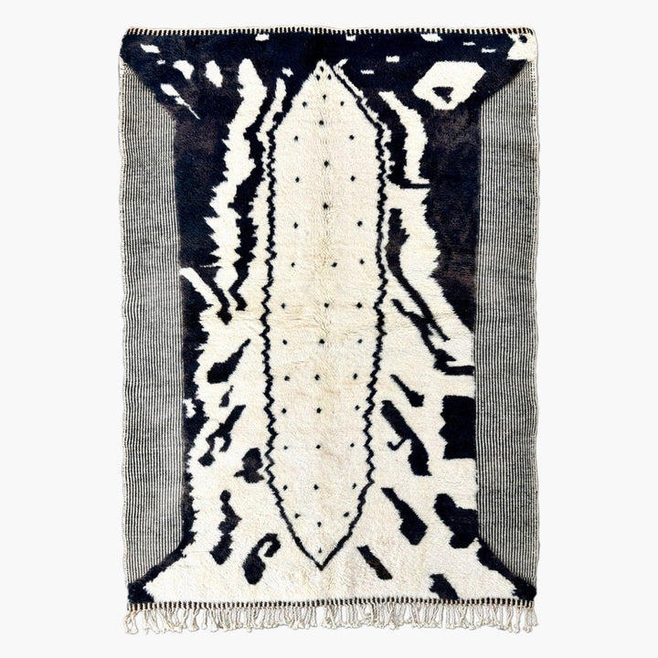 Front view of the black and white zebra print rug with fringe edges on a white background.
