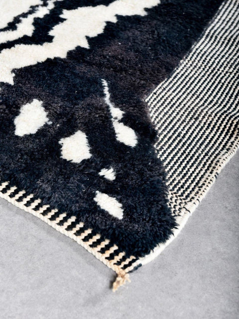 Close-up detail of the textured surface of the zebra print rug with polka dots.