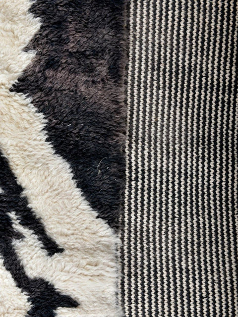 Close-up detail of the zebra print rug highlighting its textured surface and abstract design.